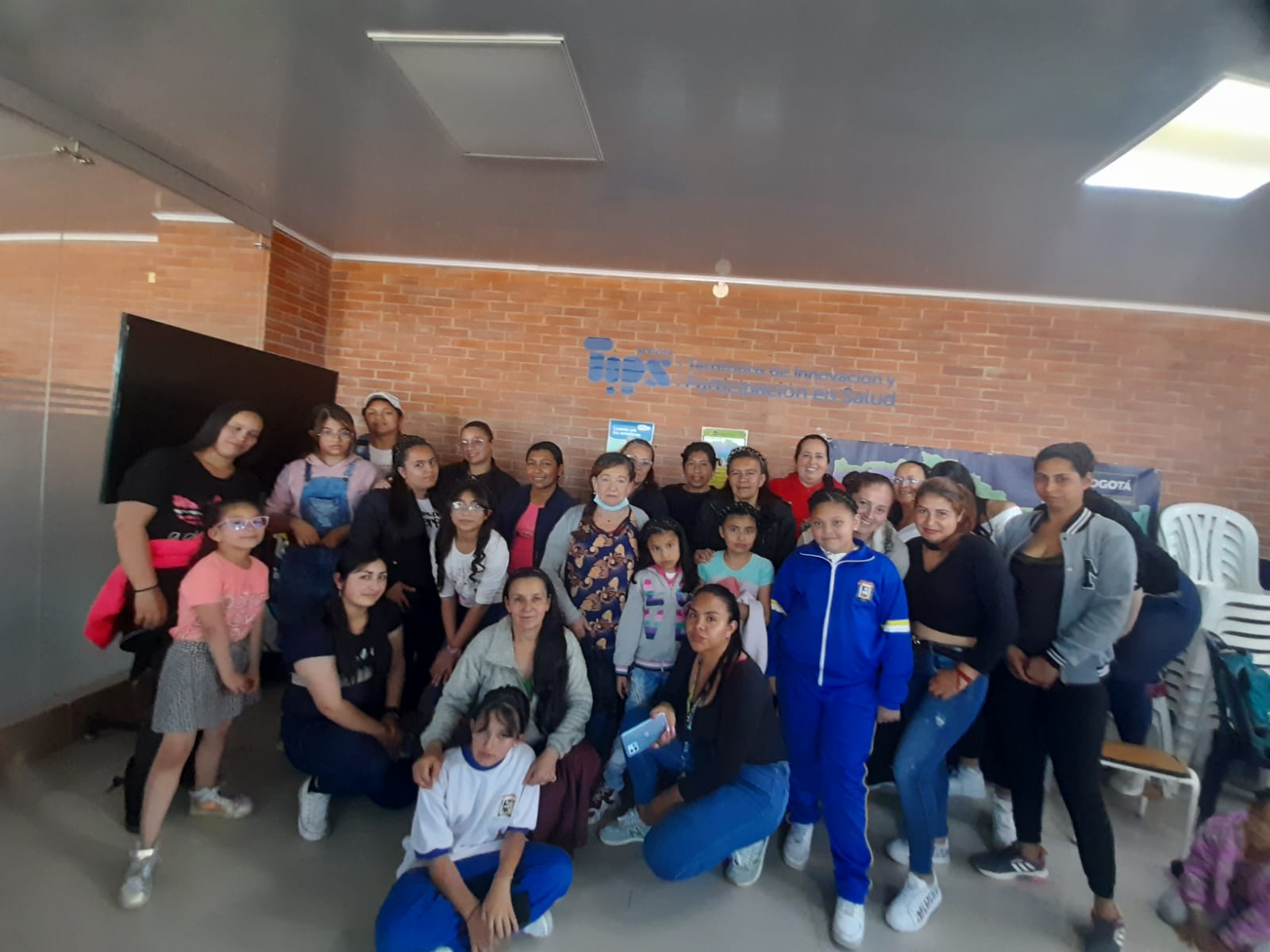 Grupo diverso frente a vitrina decorada con corazones en sede de la Fundación Rosas del Carmelo, Bogotá