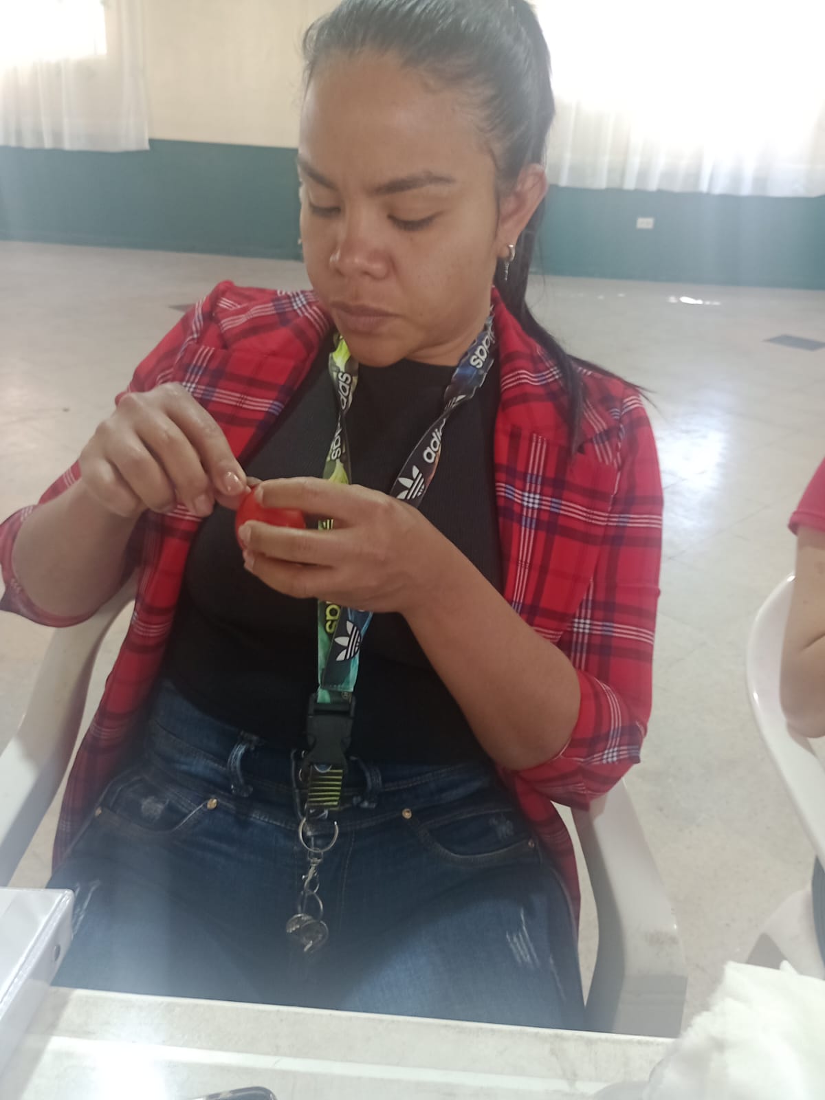 Estudiante practicando manicura con lima sobre uña postiza, curso de belleza, Fundación Rosas del Carmelo